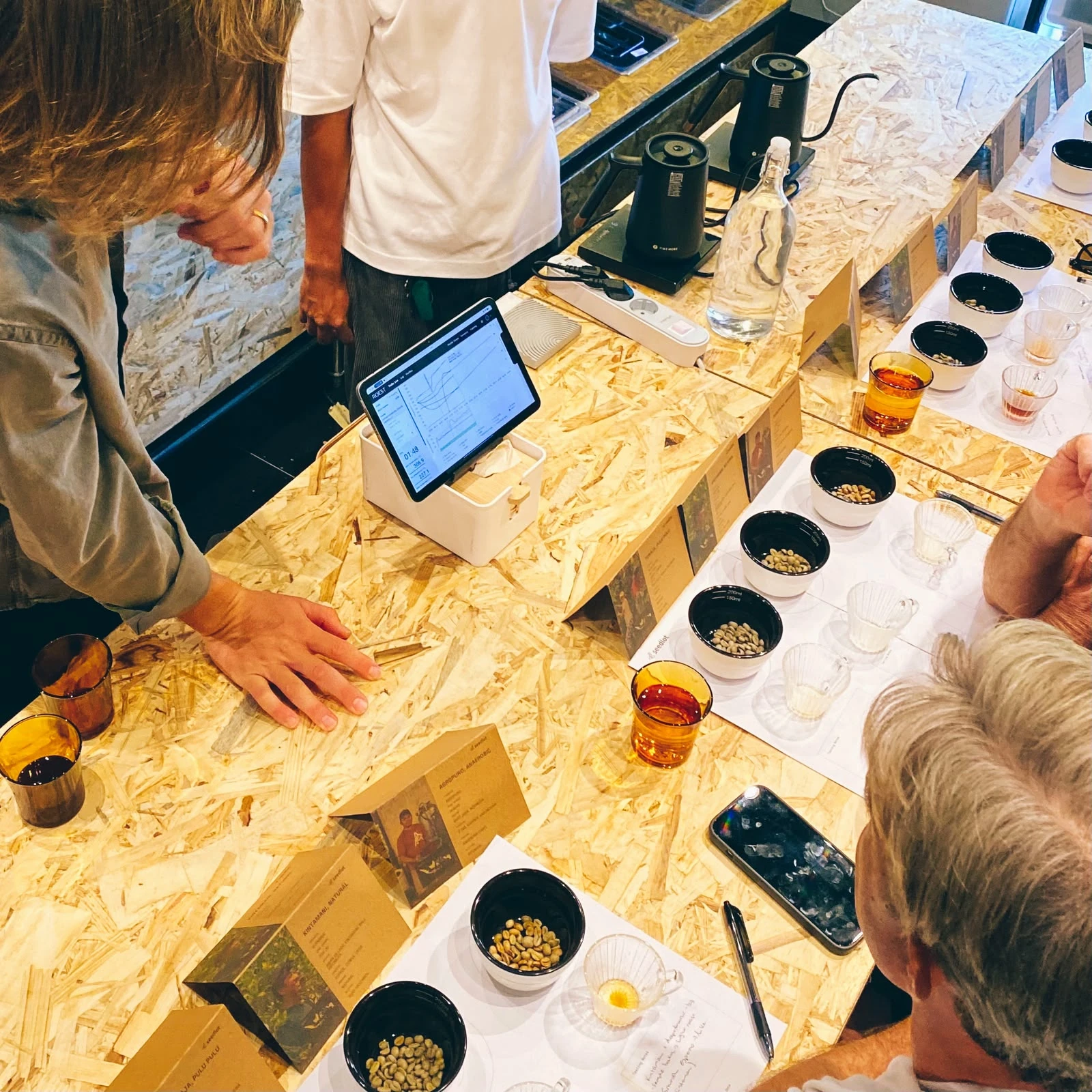 People tasting coffee together at the Seedlot workshop table