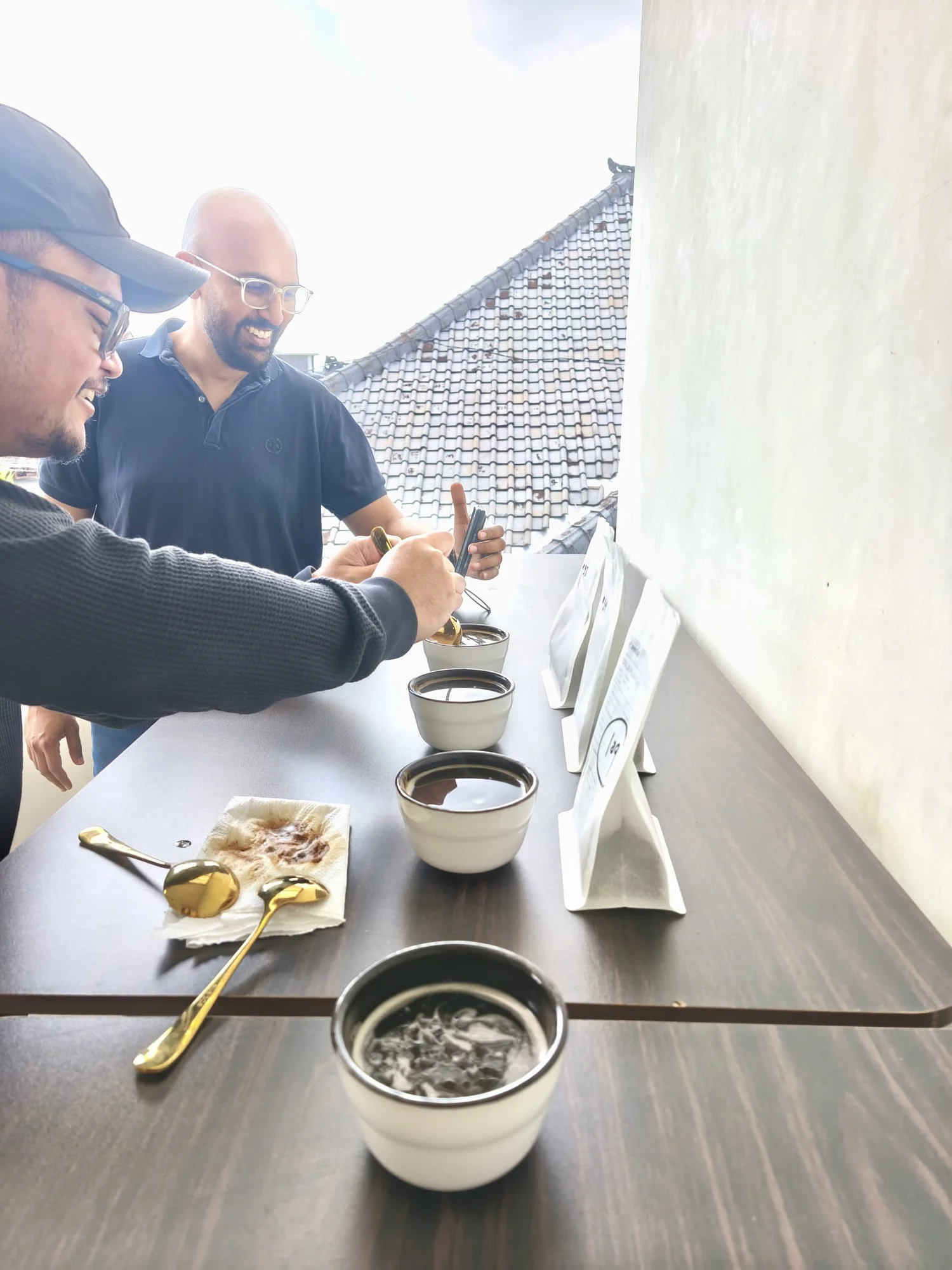 Participants tasting coffee together at the cupping table