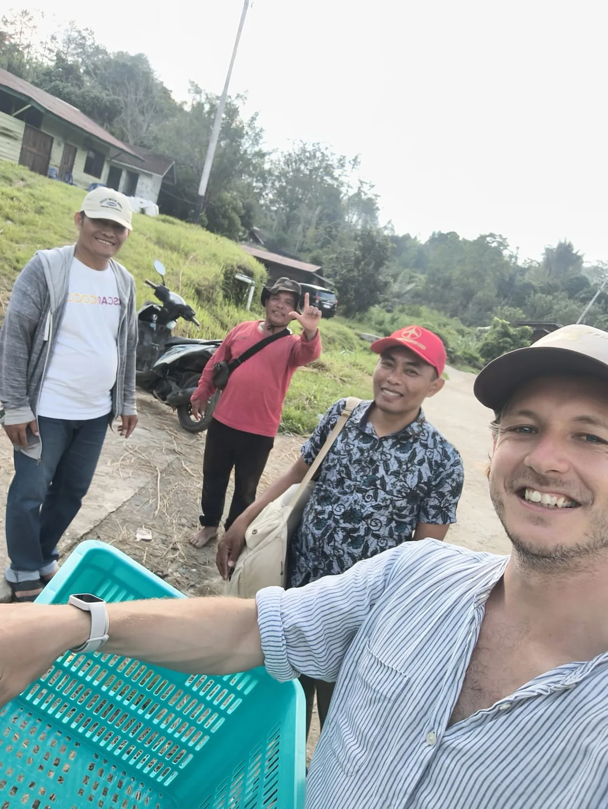 A group gathering outdoors during a visit to coffee origin