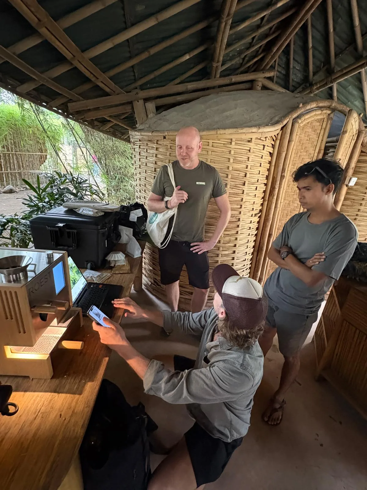 A group exploring coffee roasting together around a ROEST roaster
